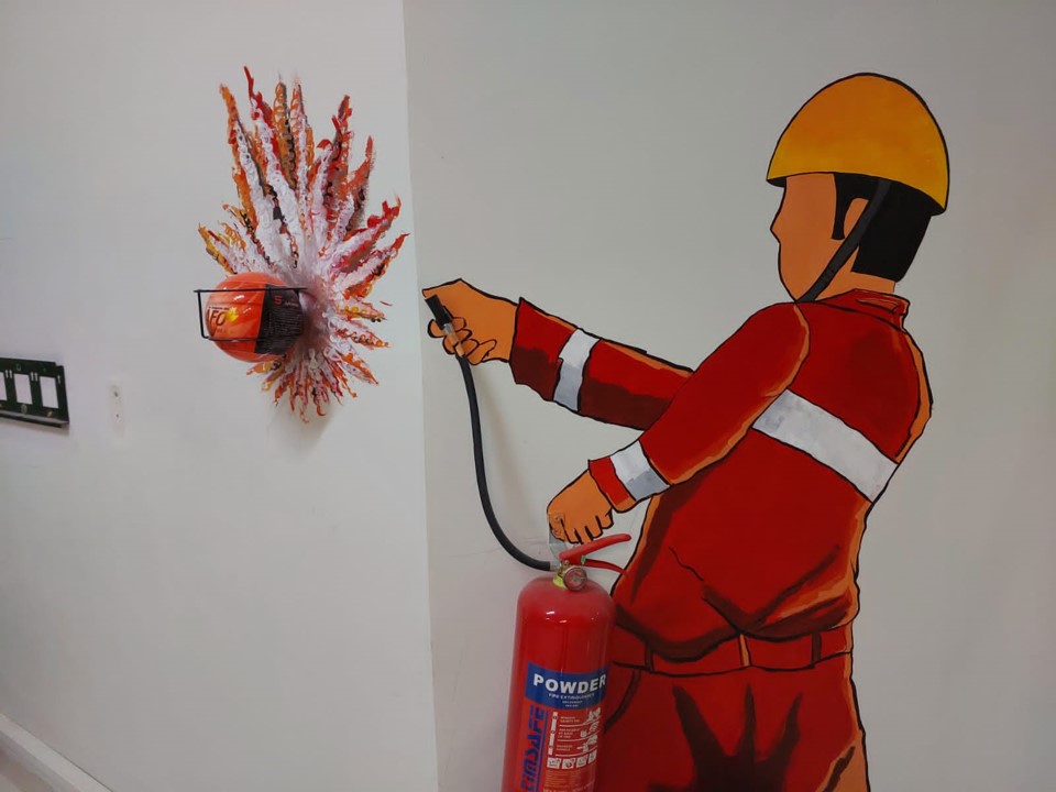 a fire extinguisher painting on a wall